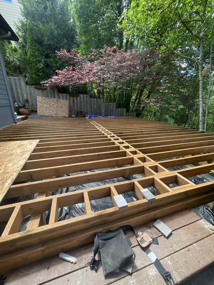 New deck framing and joists installed during two-tier deck rebuild