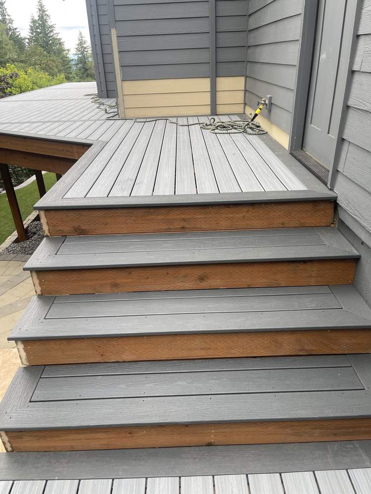 Finished deck stairs with gray composite treads by Gravelle Construction