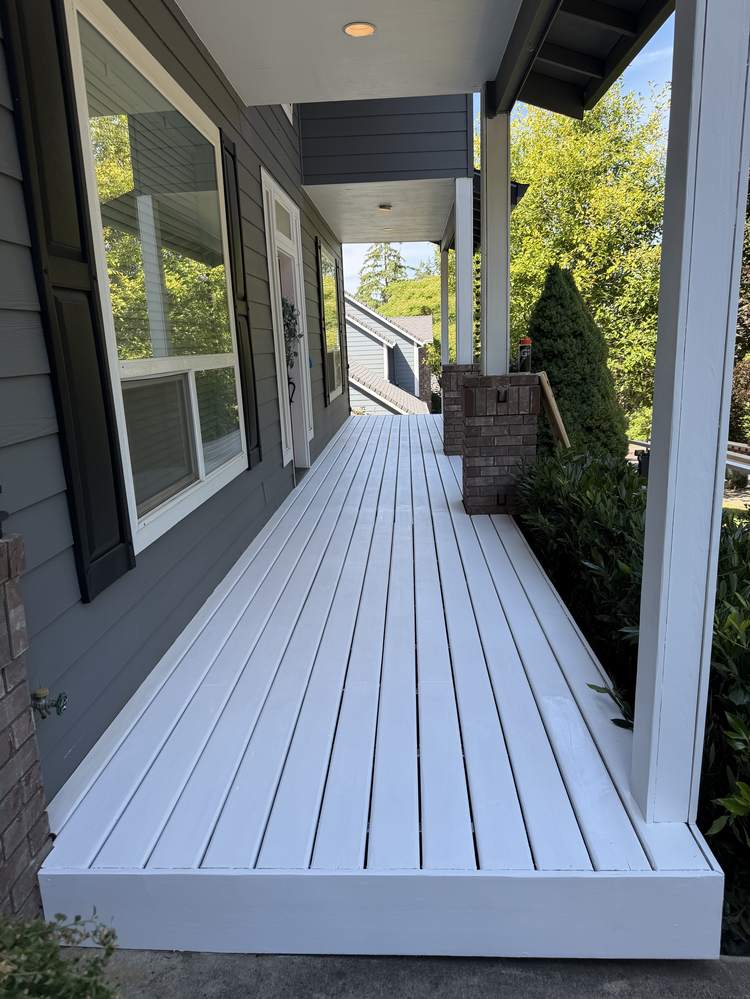Front porch walkway with primer coat applied during painting