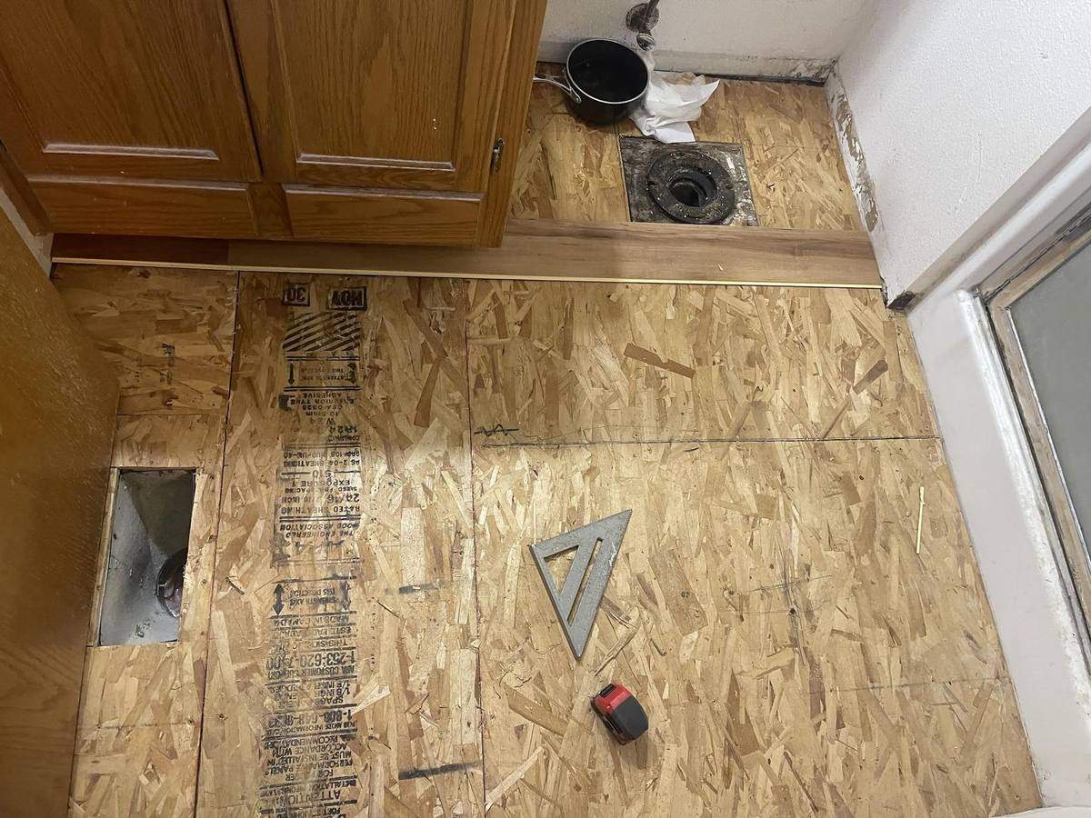 New plywood subfloor installed during bathroom floor replacement