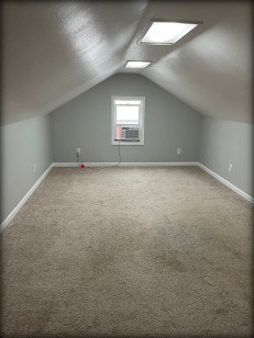 Carpeted bonus room before flooring replacement
