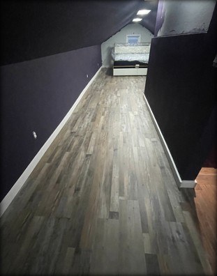 Finished bonus room with new LVT plank flooring by Gravelle Construction