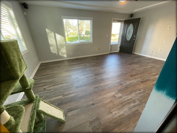 Living room with new dark LVT plank flooring installed by Gravelle Construction