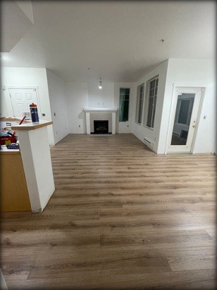 Living room with new luxury vinyl plank flooring installed by Gravelle Construction