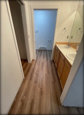 Bathroom and hallway with new luxury vinyl plank flooring installed by Gravelle Construction