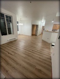 Dining room and bedroom with new luxury vinyl plank flooring installed by Gravelle Construction