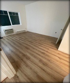 Master bedroom with new luxury vinyl plank flooring installed by Gravelle Construction