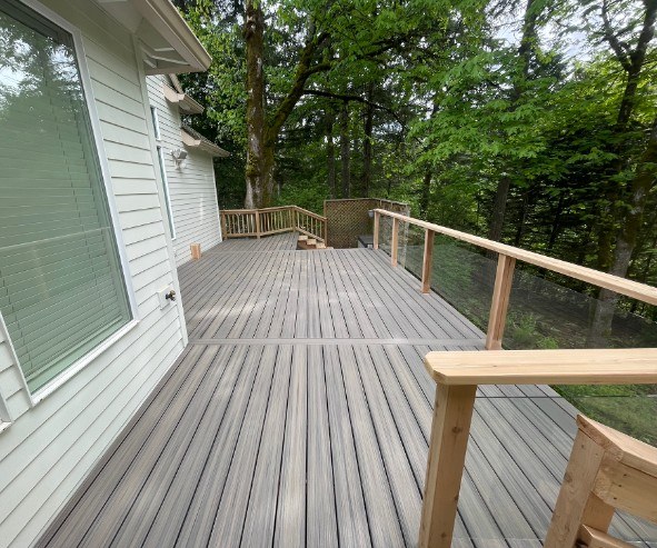 Upper deck with new composite decking and cable railing built by Gravelle Construction