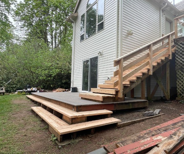 Lower deck and new cedar stairway viewed from the yard, built by Gravelle Construction