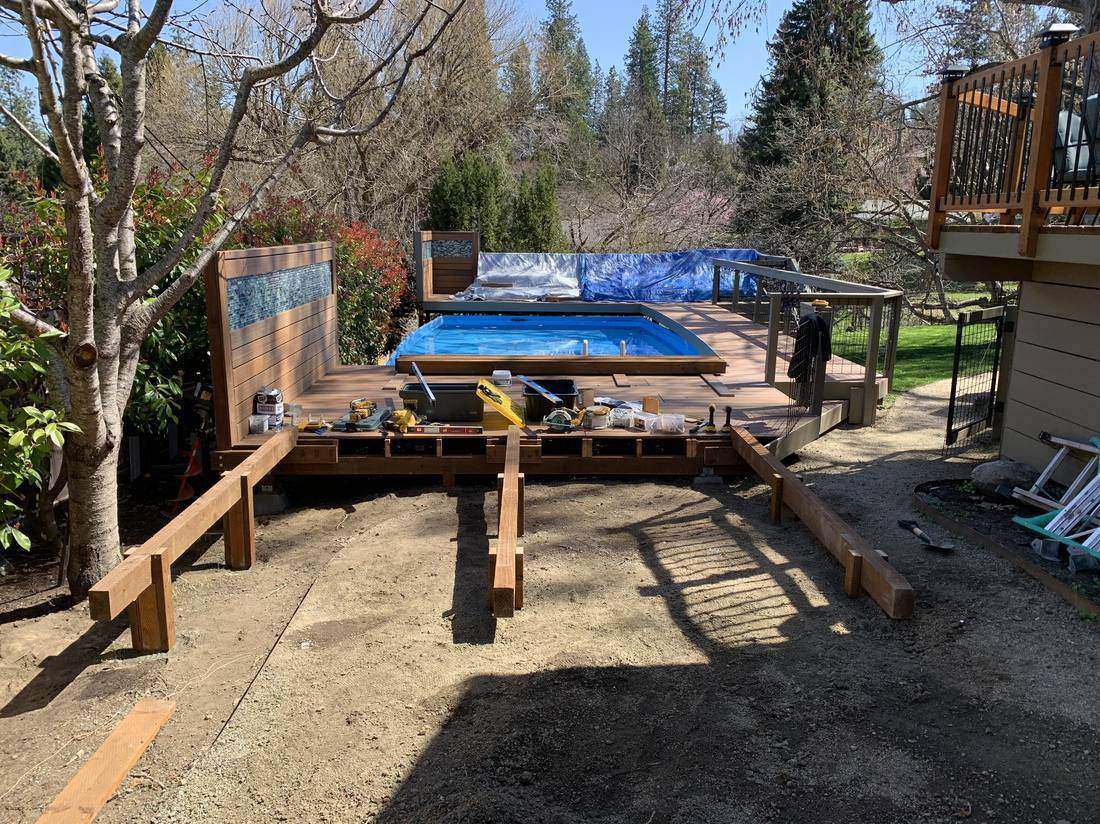 Pool deck under construction with tiled accent wall going up