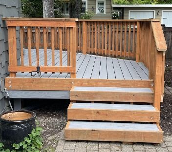 New stained wood deck steps and railing built by Gravelle Construction