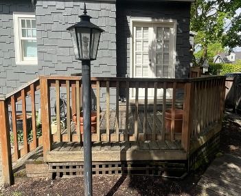 Worn deck railing before rebuild, viewed from the lamp post