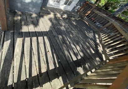 Worn, weathered deck boards before replacement