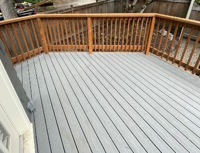 New composite deck surface with wood railing built by Gravelle Construction