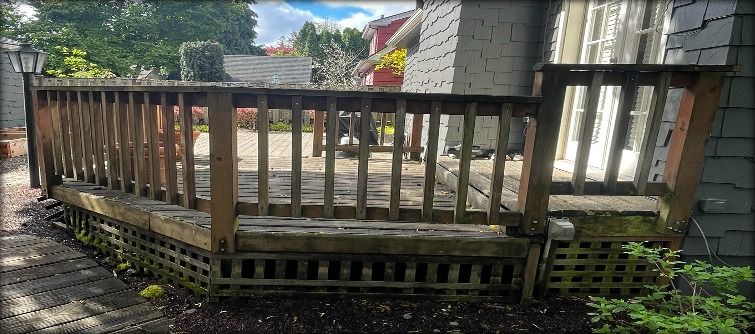 Full view of worn deck and railing before rebuild