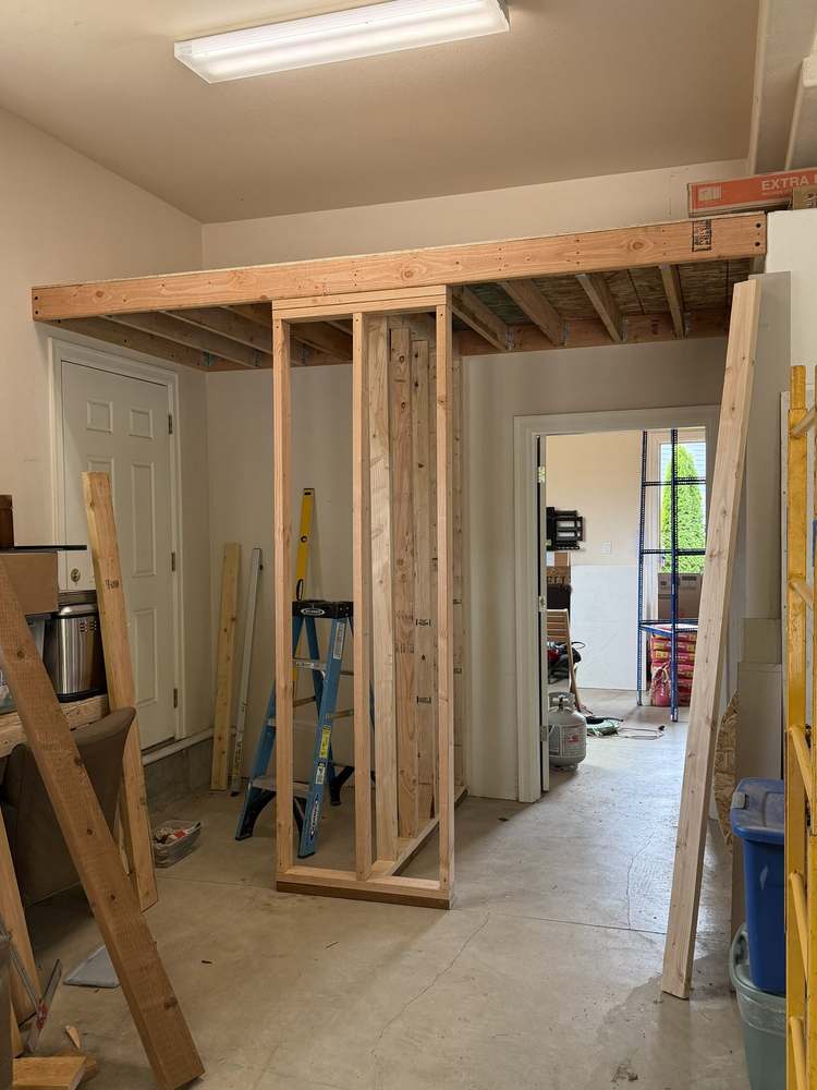 Framed support wall built under garage storage loft