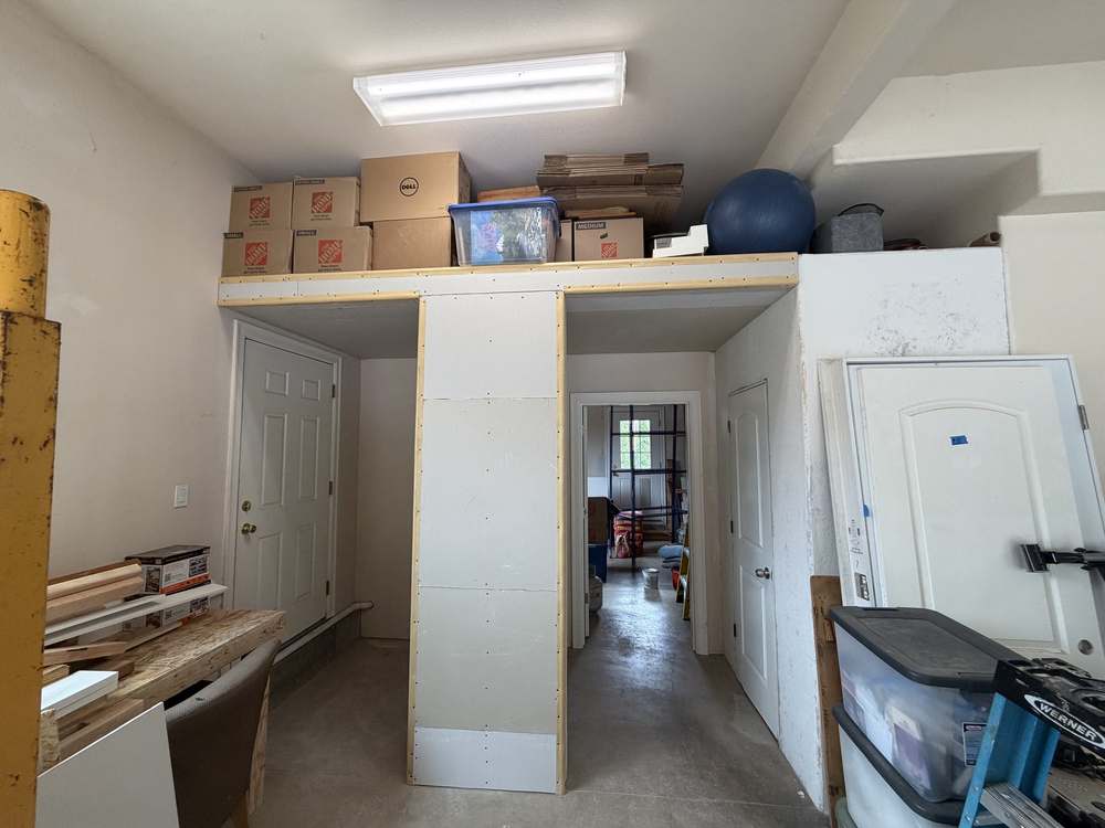 Garage storage loft with drywall installed before paint
