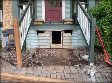 Porch steps removed exposing old damaged framing