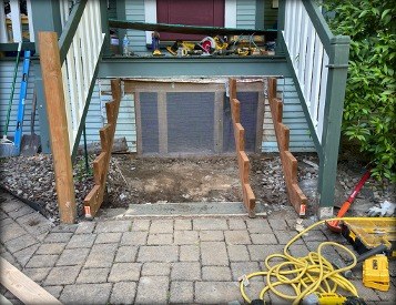 New porch step framing boxed in with skirt panel