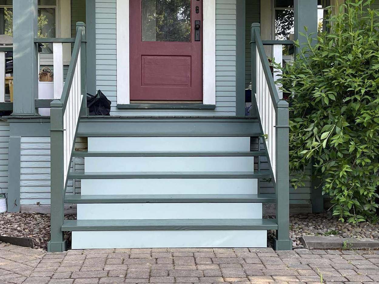 Rebuilt porch steps and railing, painted to match the house, by Gravelle Construction