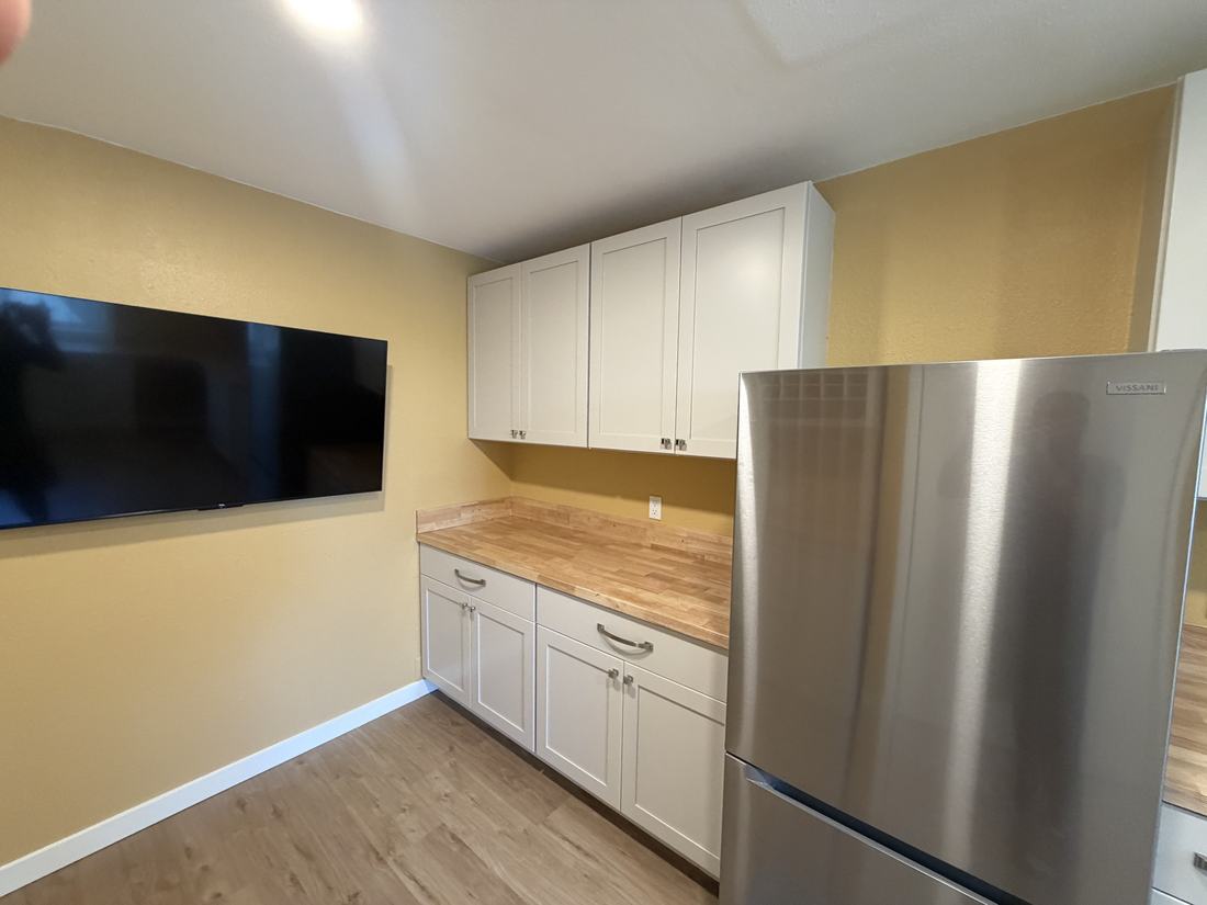 Renovated hobby room built-in desk with butcher block counter and new window