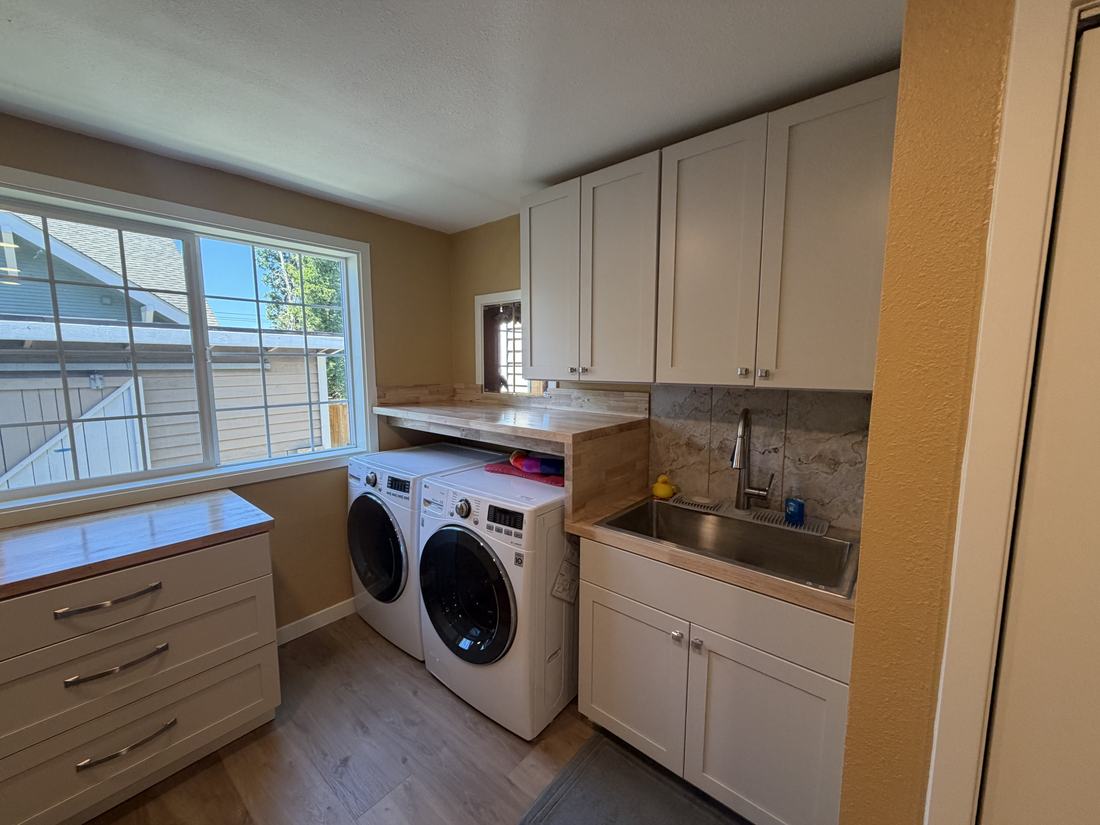 Renovated hobby room with new stainless refrigerator and cabinetry by Gravelle Construction