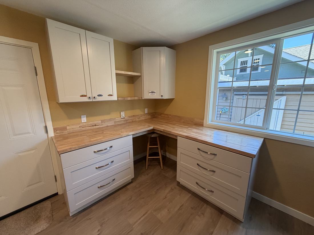 Renovated hobby room with new flooring, cabinetry and wine storage