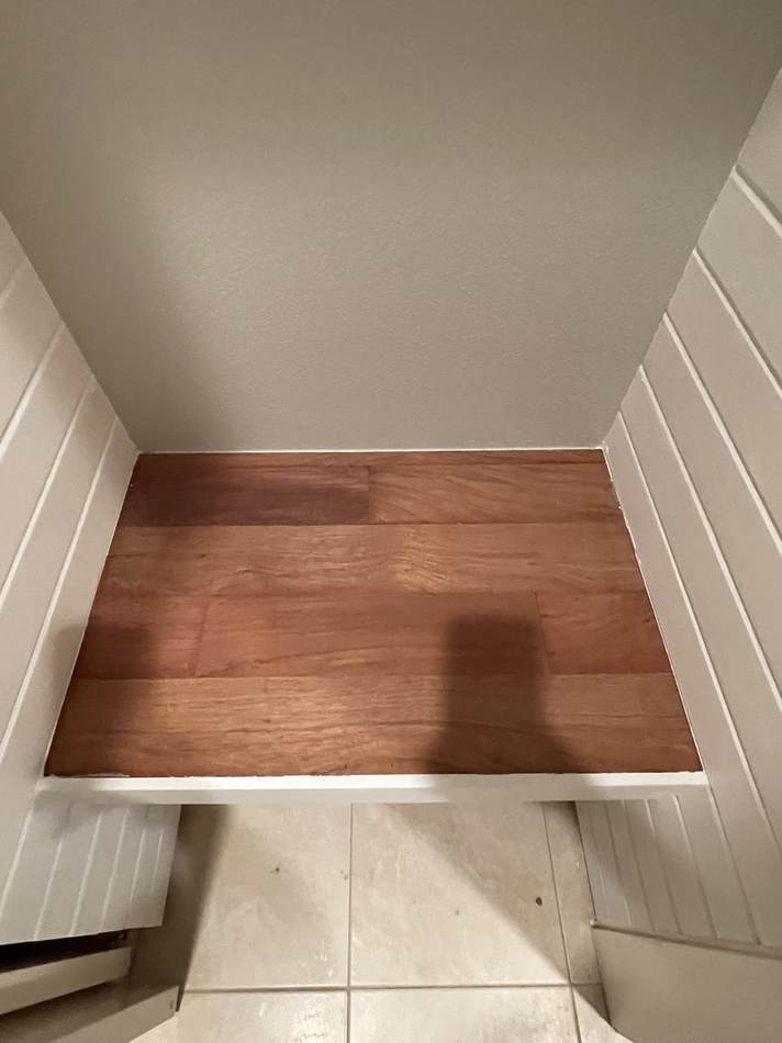 Built-in entryway closet cubbies with butcher block bench seats