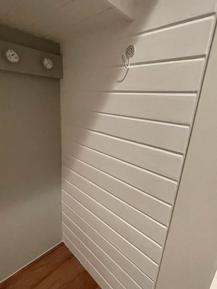Entryway cubby with shiplap paneling and coat hooks