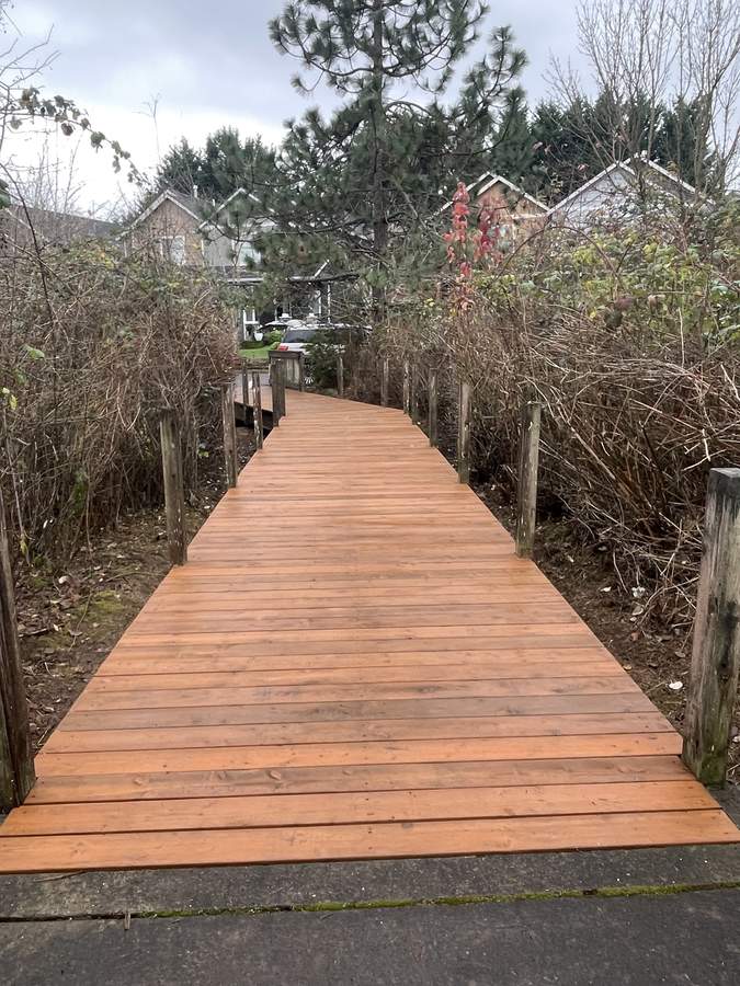 Resurfaced walking bridge with new decking by Gravelle Construction